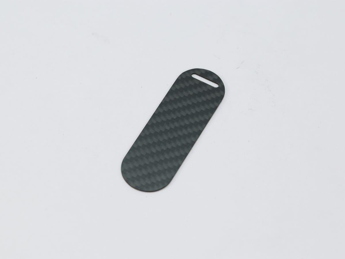Capsule Hang Tag – Carbon Fiber | Modern Design — carbon fiber close-up view 2