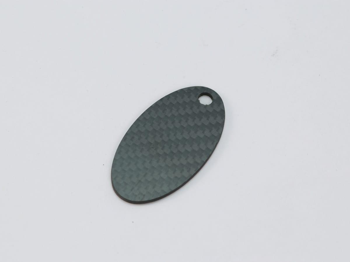 Shield Hang Tag – Carbon Fiber | Bold Statement — carbon fiber close-up view 2