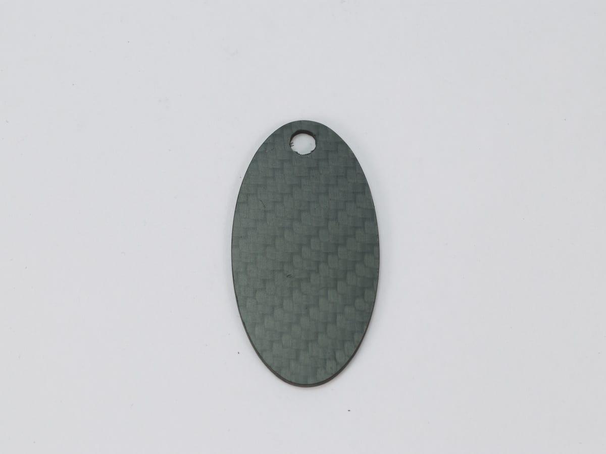 Shield Hang Tag – Carbon Fiber | Bold Statement — carbon fiber close-up view 1