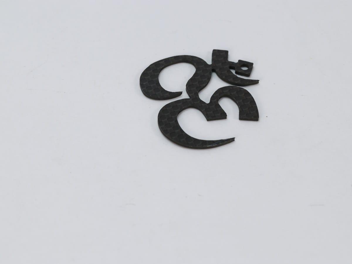 Carbon Fiber Om Pendant – Hypoallergenic & Waterproof | Spiritual Design — carbon fiber close-up view 2