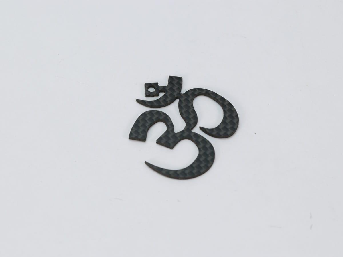 Carbon Fiber Om Pendant – Hypoallergenic & Waterproof | Spiritual Design — carbon fiber close-up view 3